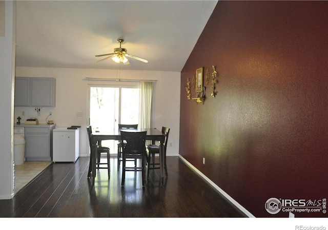 dining area featuring a ceiling fan, dark wood finished floors, and baseboards