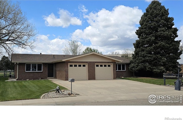 1909 Meadow Dr, Longmont, CO 80501 - ranch-style home with an attached garage, brick siding, a front yard, and driveway