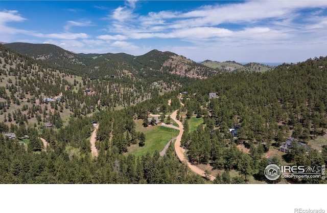 aerial view of a mountainous background and a heavily wooded area