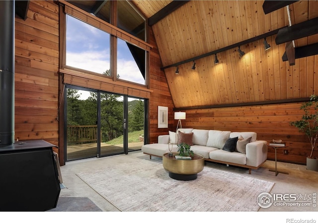carpeted living room featuring high vaulted ceiling, wood walls, wood ceiling, a wood stove, and beamed ceiling