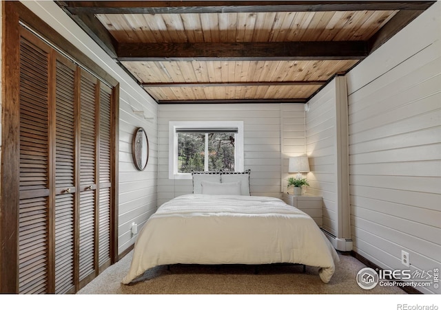 carpeted bedroom with wood ceiling, beamed ceiling, wooden walls, and a baseboard heating unit