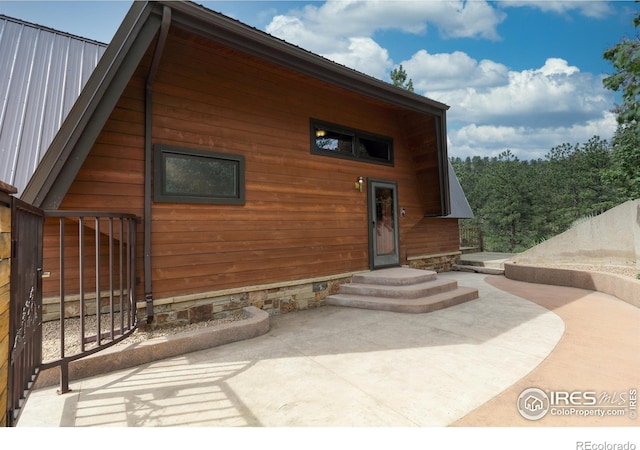 rear view of property featuring a patio area