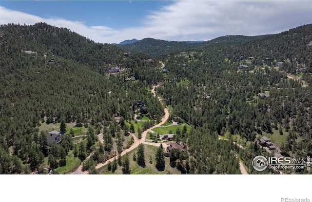 bird's eye view of a heavily wooded area and mountains