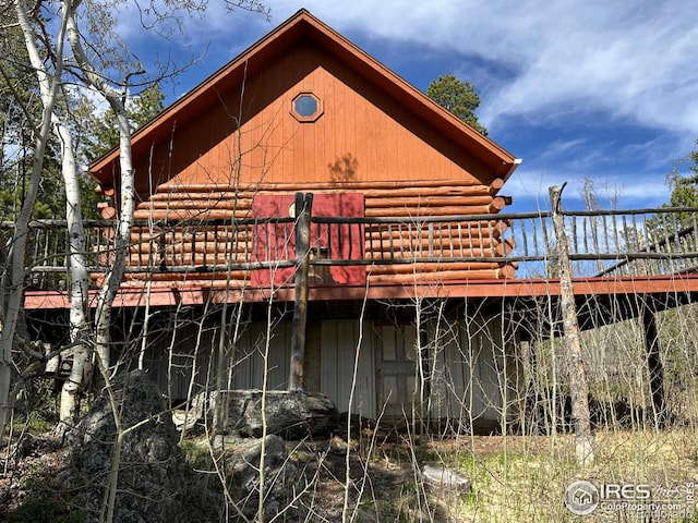 4911 Storm Mountain Dr, Drake, CO 80515 - rear view of property with log exterior and a deck