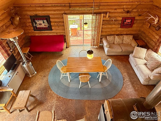 4911 Storm Mountain Dr, Drake, CO 80515 - carpeted living area featuring rustic walls