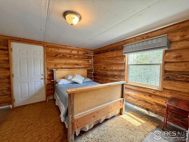 4911 Storm Mountain Dr, Drake, CO 80515 - bedroom with log walls and carpet flooring