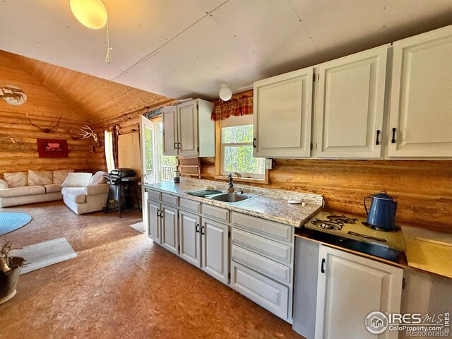 4911 Storm Mountain Dr, Drake, CO 80515 - kitchen featuring a sink, log walls, lofted ceiling, open floor plan, and wood ceiling