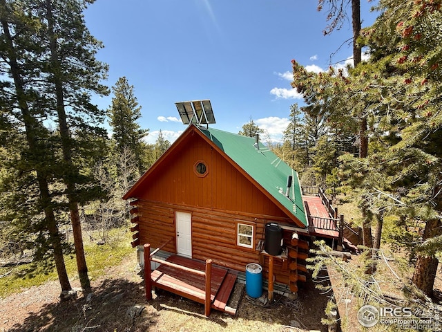4911 Storm Mountain Dr, Drake, CO 80515 - view of side of property with log exterior and metal roof