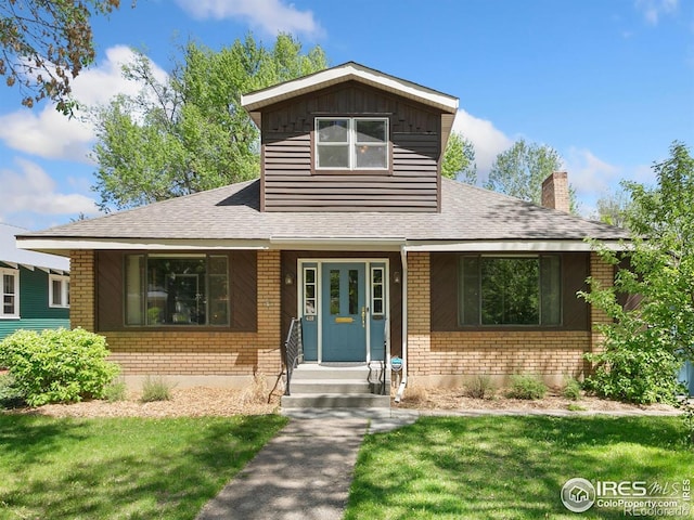 618 Whedbee St, Fort Collins, CO 80524 - view of front of property with brick siding, roof with shingles, a chimney, and a front lawn