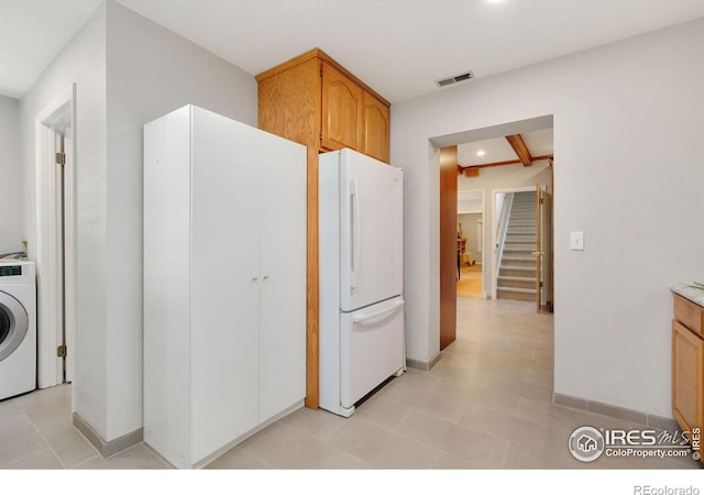 618 Whedbee St, Fort Collins, CO 80524 - kitchen with freestanding refrigerator, washer / dryer, light countertops, and baseboards