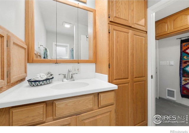 618 Whedbee St, Fort Collins, CO 80524 - bathroom with vanity, decorative backsplash, and tile patterned flooring