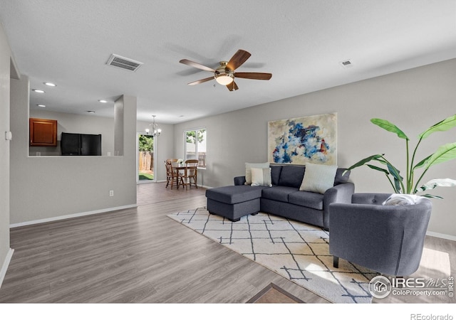 living area with a ceiling fan, a chandelier, baseboards, and recessed lighting