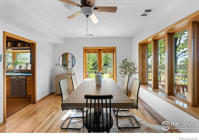 4743 Jay Rd, Boulder, CO 80301 - dining space featuring a textured ceiling, plenty of natural light, light wood-type flooring, ceiling fan, and baseboards