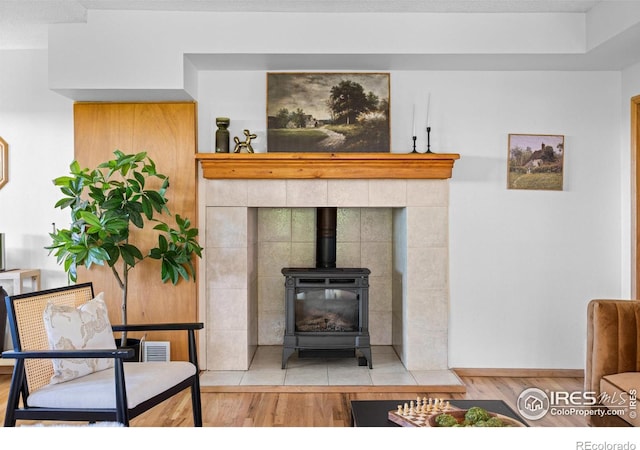 4743 Jay Rd, Boulder, CO 80301 - living area with wood finished floors, a wood stove, and baseboards
