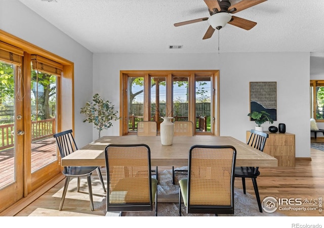 4743 Jay Rd, Boulder, CO 80301 - dining area with french doors, plenty of natural light, a textured ceiling, and wood finished floors