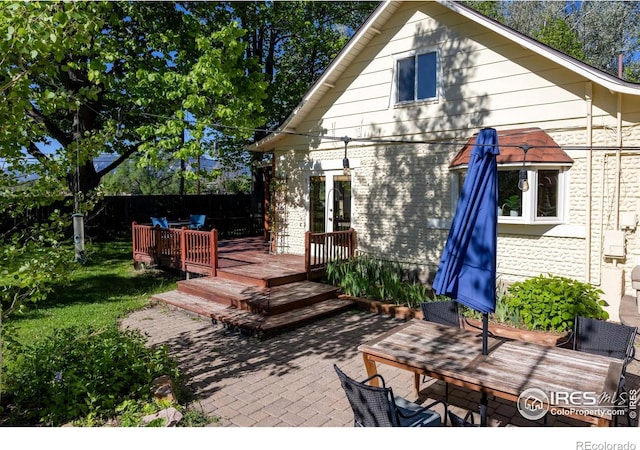 4743 Jay Rd, Boulder, CO 80301 - back of property featuring a wooden deck, brick siding, a patio area, and french doors