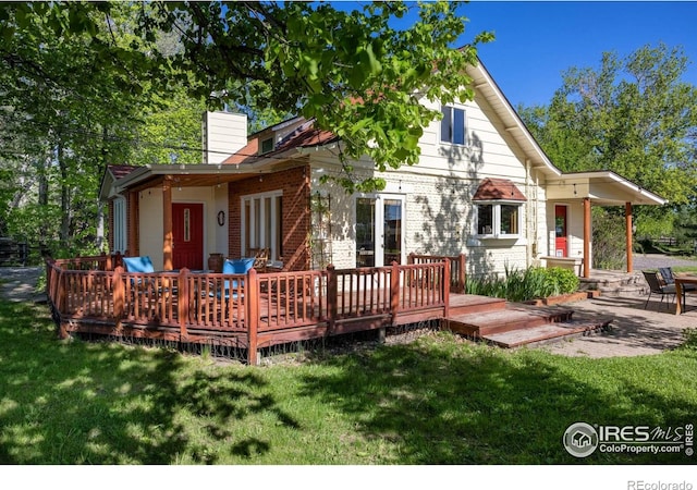 4743 Jay Rd, Boulder, CO 80301 - back of house featuring a chimney, a deck, and a lawn