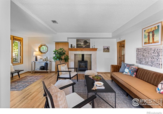 4743 Jay Rd, Boulder, CO 80301 - living area with a textured ceiling, a wood stove, wood finished floors, and baseboards