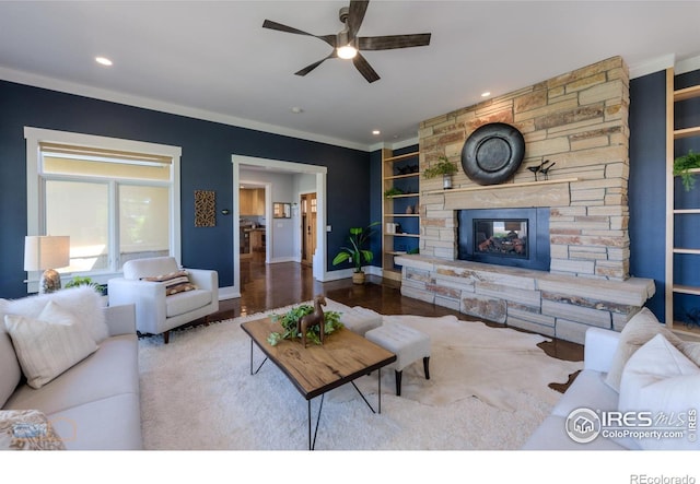 23111 County Road 1, Berthoud, CO 80513 - living area featuring ceiling fan, built in shelves, a fireplace, crown molding, and baseboards