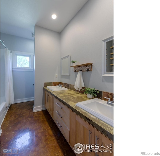 23111 County Road 1, Berthoud, CO 80513 - bathroom featuring concrete floors, double vanity, baseboards, and recessed lighting