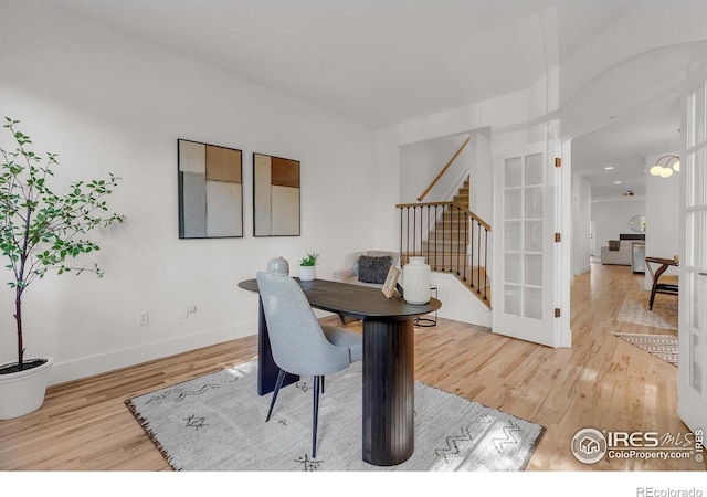 home office featuring wood finished floors, baseboards, and french doors