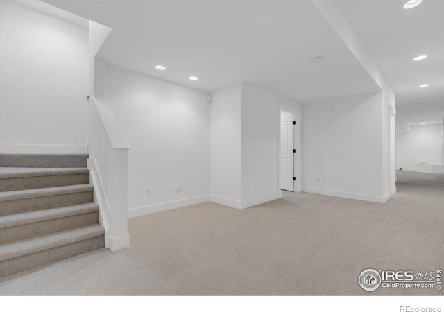 unfurnished living room featuring carpet flooring, baseboards, and recessed lighting