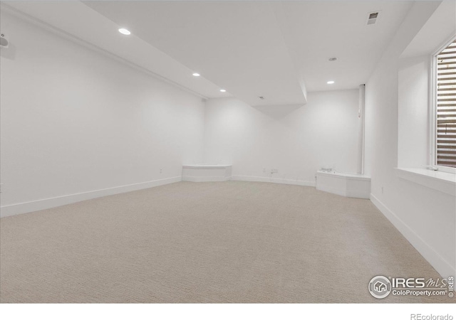 empty room featuring recessed lighting, carpet flooring, and baseboards