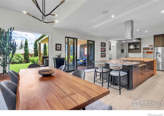 dining space featuring light tile patterned flooring, a chandelier, and recessed lighting