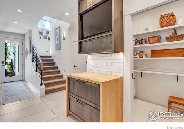 kitchen with light tile patterned floors, wooden counters, recessed lighting, tasteful backsplash, and baseboards