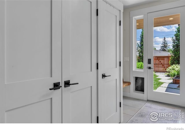 doorway with light tile patterned floors