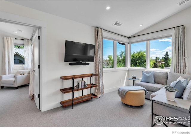 carpeted living area featuring healthy amount of natural light, vaulted ceiling, recessed lighting, and baseboards