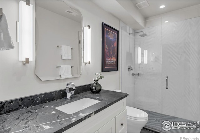full bath with a stall shower, toilet, vanity, and recessed lighting