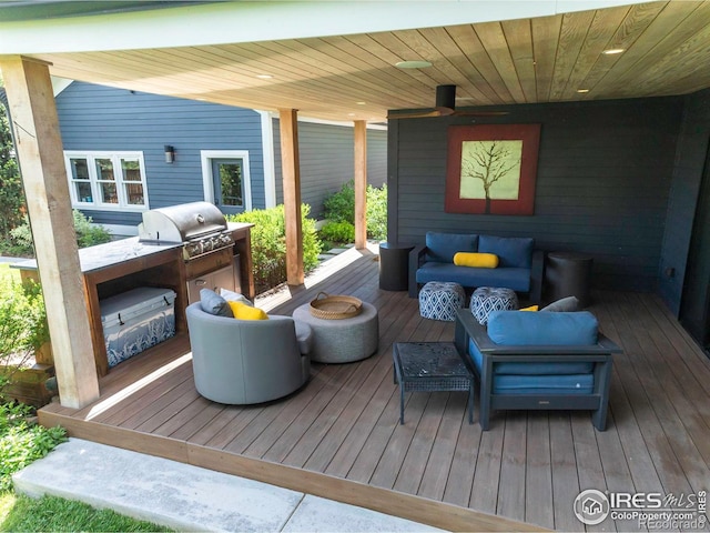 wooden deck featuring a grill