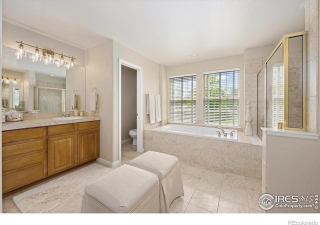 full bath with a stall shower, toilet, vanity, a bath, and tile patterned flooring