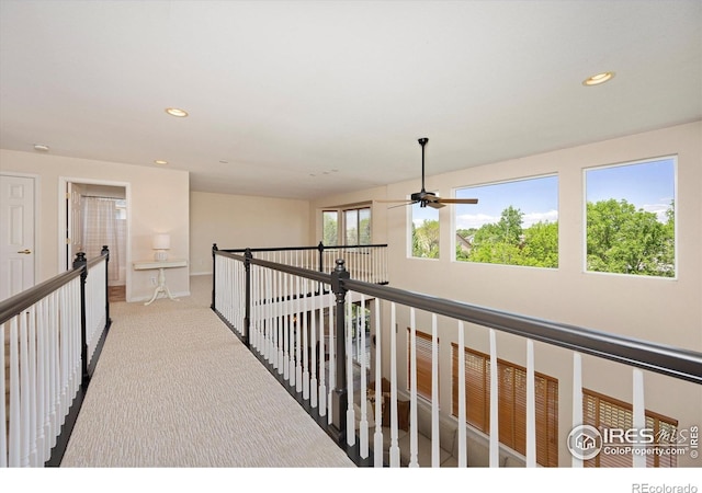 hallway featuring carpet floors, recessed lighting, an upstairs landing, and baseboards