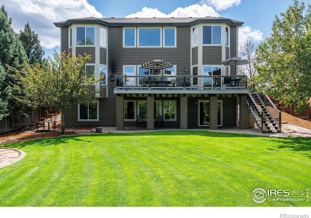 back of house featuring a wooden deck, a patio, and stairs