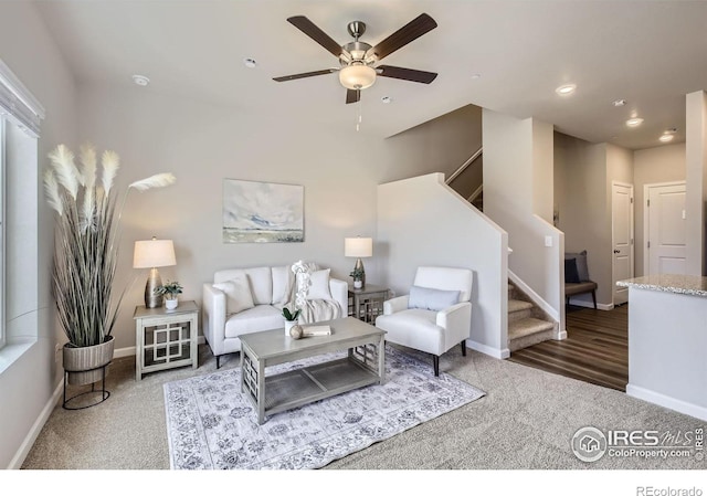 carpeted living area with ceiling fan, stairs, baseboards, and recessed lighting