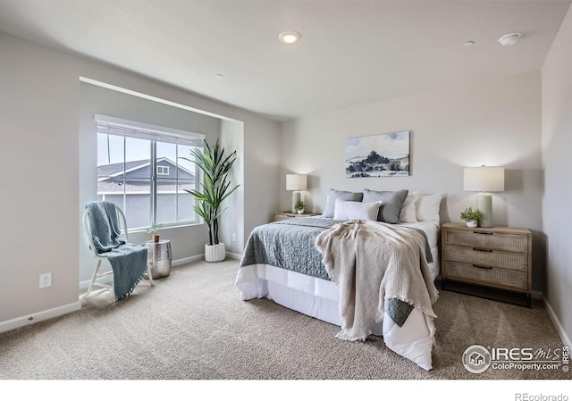 bedroom featuring carpet flooring and baseboards
