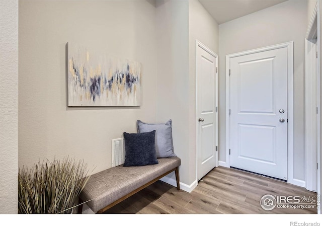 foyer with wood finished floors and baseboards