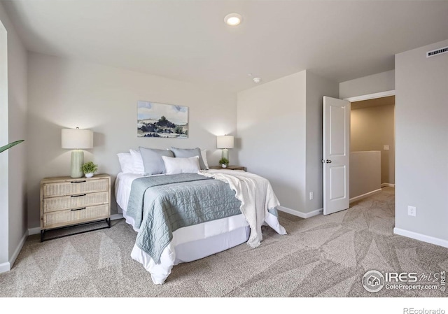 carpeted bedroom featuring baseboards and recessed lighting