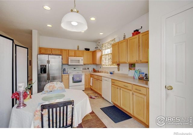 4312 Windmill Dr, Brighton, CO 80601 - kitchen with white appliances, a sink, light countertops, light brown cabinetry, and recessed lighting