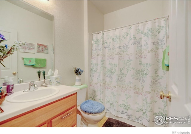4312 Windmill Dr, Brighton, CO 80601 - full bathroom with toilet, vanity, and a shower with curtain