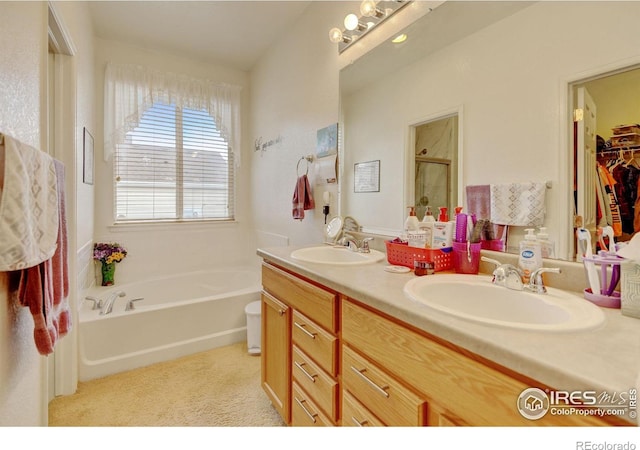 4312 Windmill Dr, Brighton, CO 80601 - bathroom featuring a bath, a shower stall, double vanity, and a spacious closet
