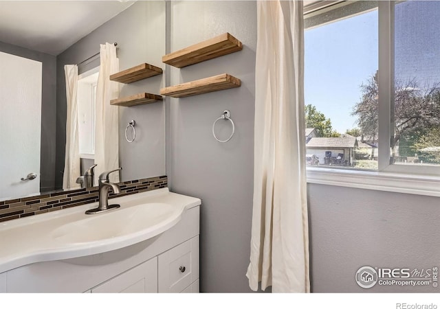 bathroom with backsplash and vanity