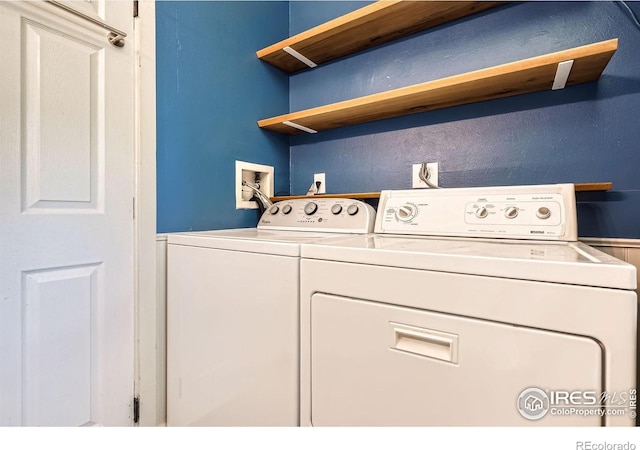 clothes washing area with washing machine and clothes dryer