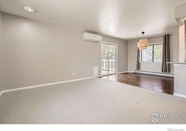empty room featuring a baseboard radiator, a wall mounted AC, carpet flooring, and baseboards