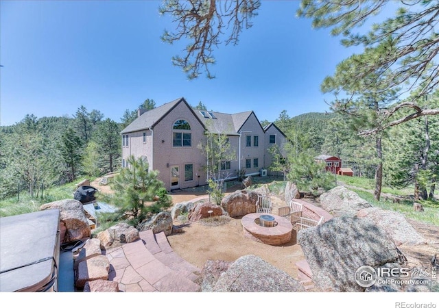 1057 Reed Ranch Rd, Boulder, CO 80302 - view of patio with a fire pit and a view of trees