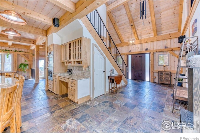 1057 Reed Ranch Rd, Boulder, CO 80302 - kitchen with wood ceiling, wood walls, double oven, glass insert cabinets, and stone finish floors