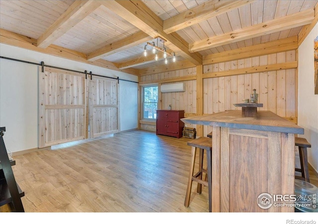1057 Reed Ranch Rd, Boulder, CO 80302 - living room featuring a barn door, an AC wall unit, beam ceiling, wooden ceiling, and wood finished floors
