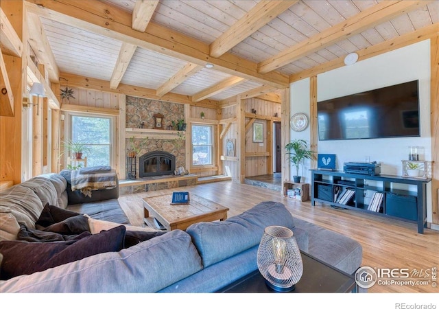 1057 Reed Ranch Rd, Boulder, CO 80302 - living room featuring healthy amount of natural light, beamed ceiling, wood finished floors, wood ceiling, and wooden walls